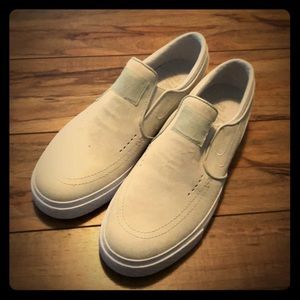 White/tan suede Nike low top slip ons